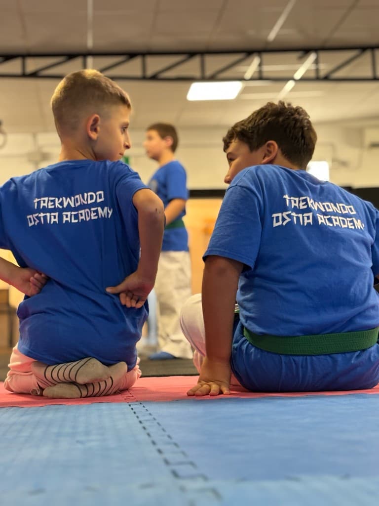 Due allievi di Taekwondo a Ostia seduti sul tatami durante l'allenamento