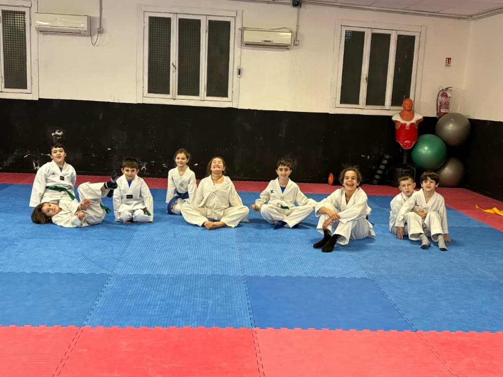 Gruppo di allievi di Taekwondo a Ostia seduti sul tatami in palestra
